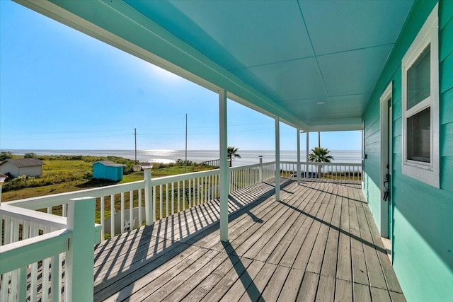 deck featuring a water view and a shed