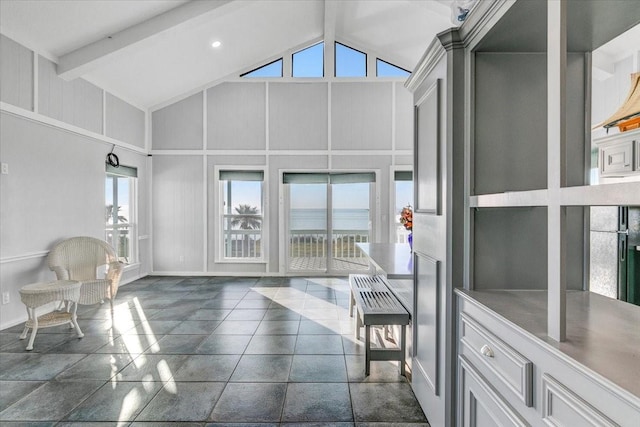 sunroom / solarium with a water view and lofted ceiling with beams