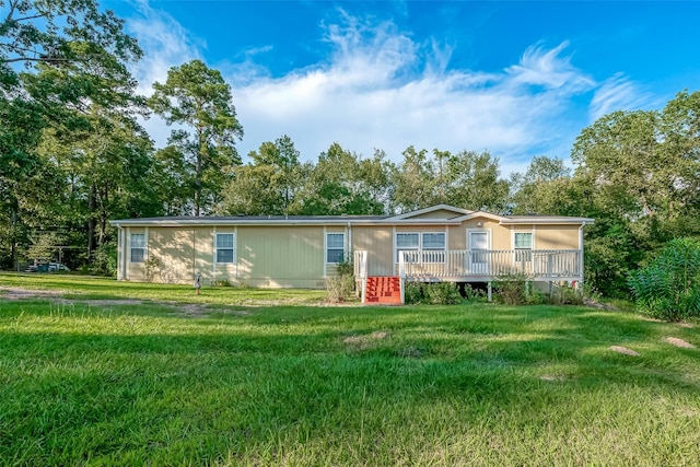 view of front facade featuring a front lawn and a deck