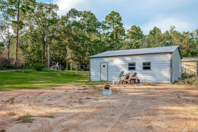 view of outbuilding featuring a yard