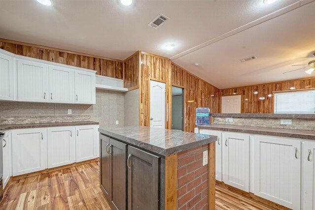 kitchen with white cabinets, a center island, light hardwood / wood-style flooring, and ceiling fan