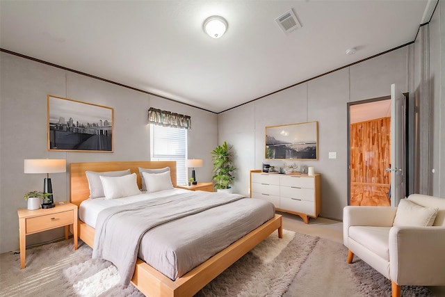 carpeted bedroom with ornamental molding