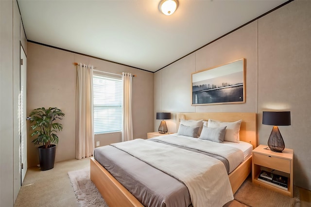 bedroom with light carpet and ornamental molding