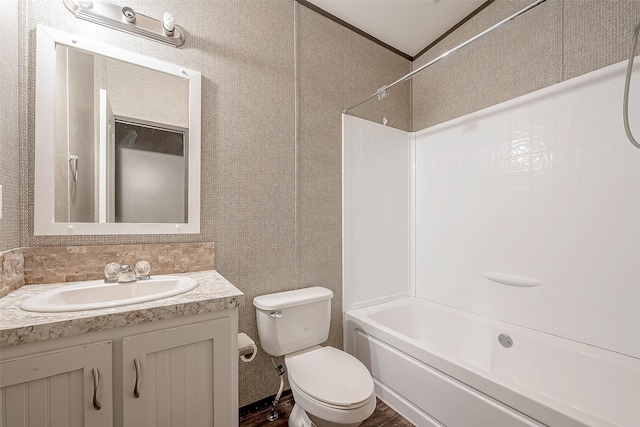 full bathroom featuring decorative backsplash, vanity, bathing tub / shower combination, crown molding, and toilet