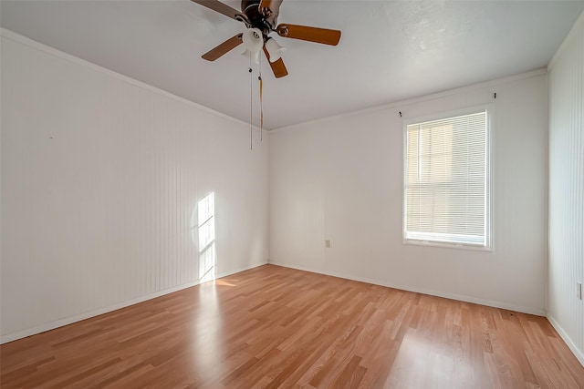 empty room with ceiling fan, light hardwood / wood-style floors, and ornamental molding