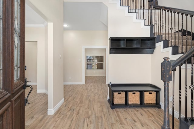 entrance foyer featuring light wood-type flooring and ornamental molding