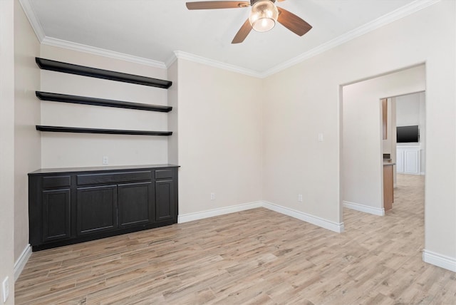 spare room with ceiling fan, crown molding, and light wood-type flooring