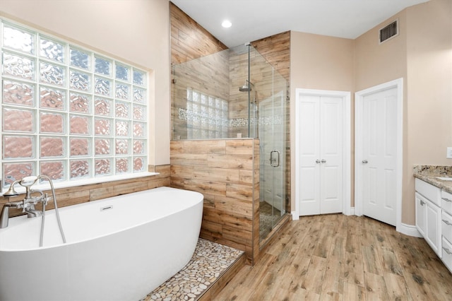 bathroom with vanity, wood-type flooring, and shower with separate bathtub