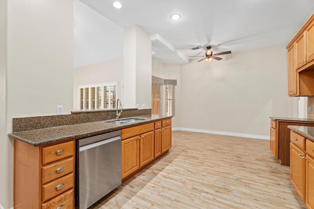 kitchen with ceiling fan, dark stone countertops, stainless steel dishwasher, sink, and light hardwood / wood-style flooring