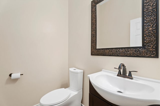 bathroom with toilet and vanity