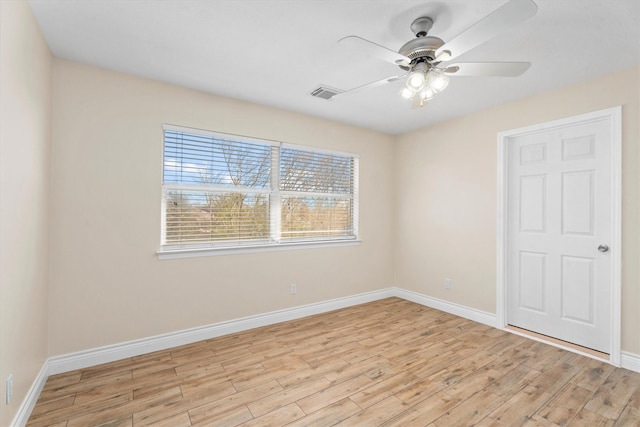 empty room with ceiling fan and light wood-type flooring