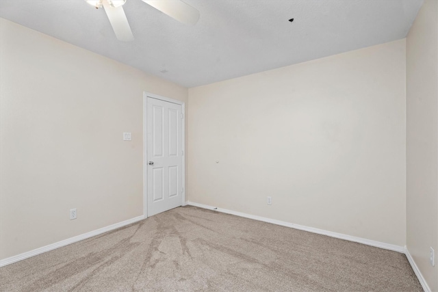 empty room with ceiling fan and carpet