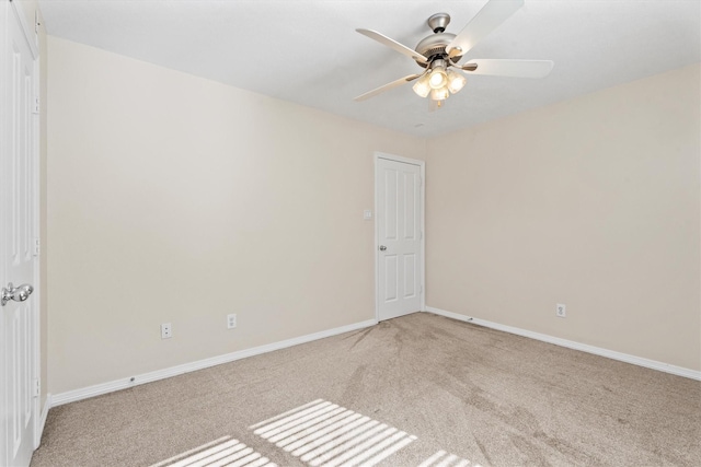 carpeted empty room featuring ceiling fan