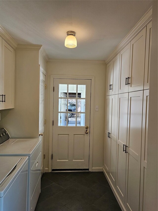 clothes washing area featuring separate washer and dryer, crown molding, cabinets, and dark tile patterned flooring