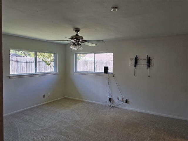 empty room featuring carpet flooring and ceiling fan