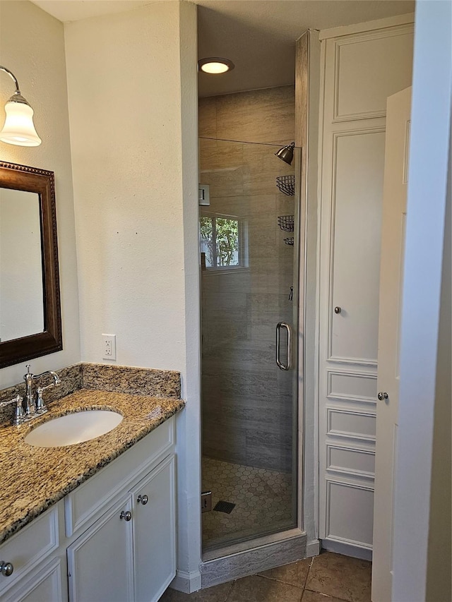 bathroom featuring tile patterned floors, vanity, and an enclosed shower