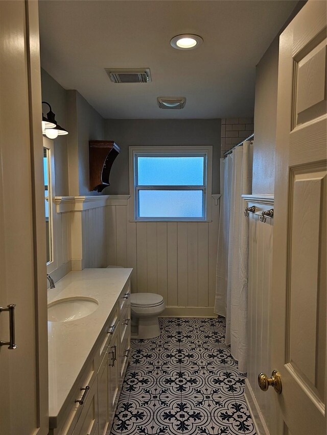 bathroom featuring toilet, vanity, and tile patterned floors