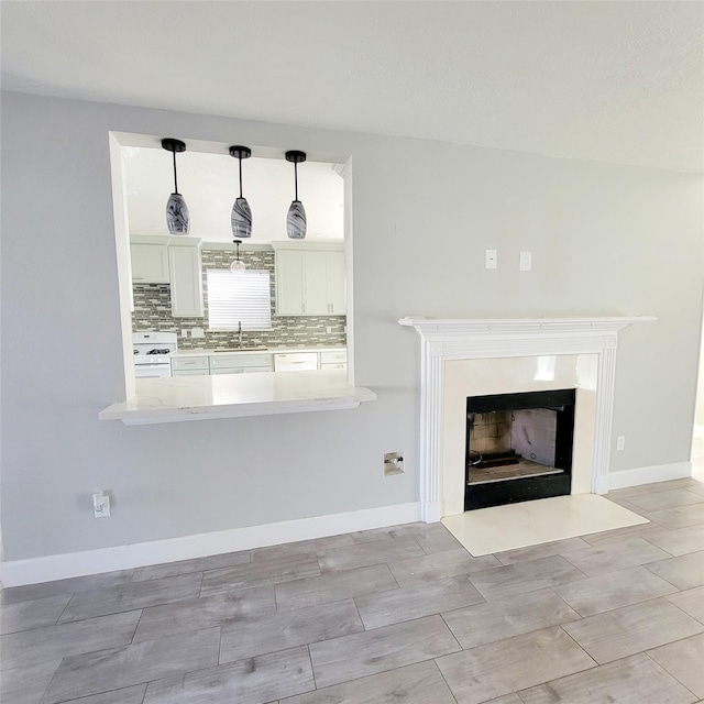 unfurnished living room featuring sink