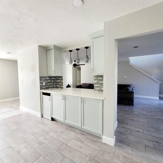 kitchen with decorative backsplash, hanging light fixtures, and ceiling fan