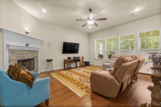 living room with ceiling fan, a fireplace, and hardwood / wood-style floors