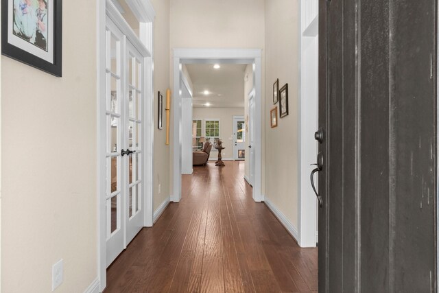 hallway featuring french doors and dark wood-type flooring