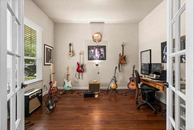 home office with heating unit, dark hardwood / wood-style flooring, and french doors