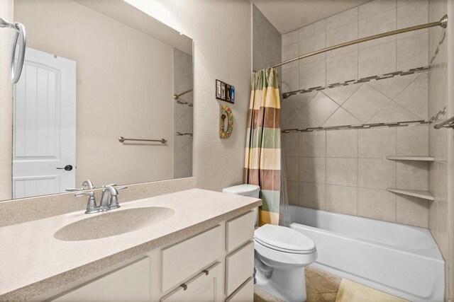 full bathroom with vanity, shower / bath combination with curtain, and toilet