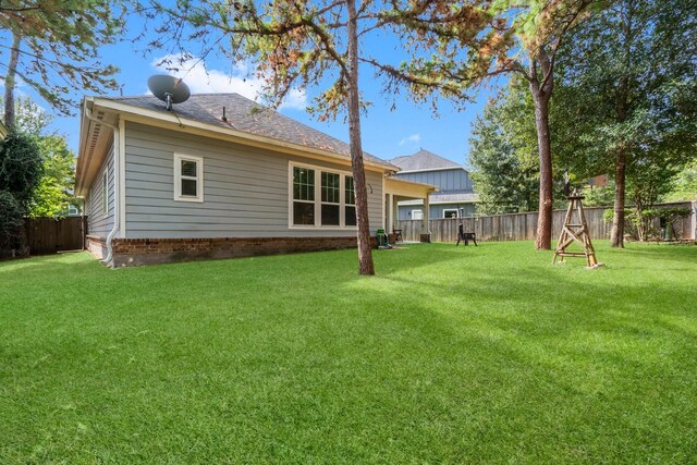 rear view of house featuring a lawn