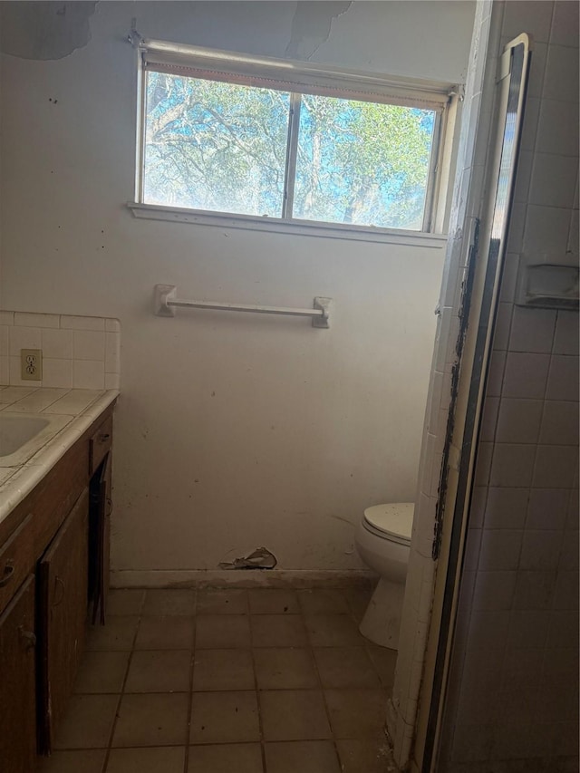 bathroom featuring tile patterned flooring, vanity, and toilet