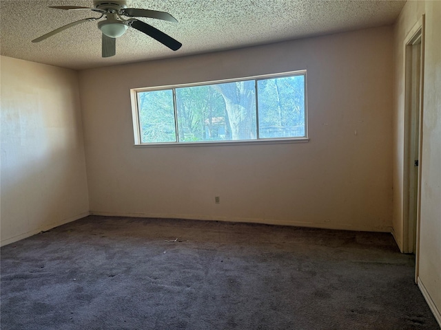 carpeted spare room featuring ceiling fan and a textured ceiling