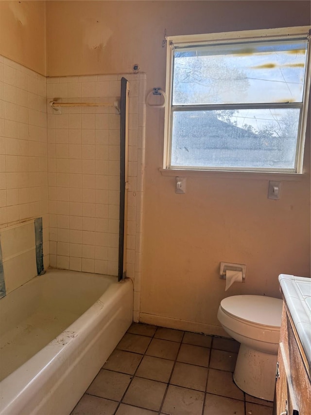 full bathroom with toilet, vanity, tile patterned floors, and tiled shower / bath combo