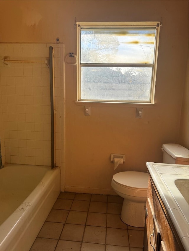 full bathroom with toilet, vanity, tile patterned floors, and tiled shower / bath combo