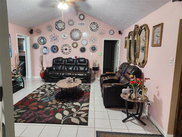 tiled living room featuring ceiling fan, lofted ceiling with beams, and a textured ceiling