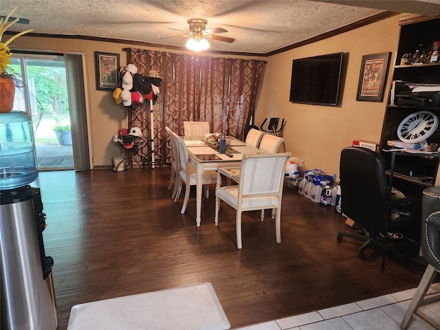 dining area with lofted ceiling, hardwood / wood-style flooring, ceiling fan, ornamental molding, and a textured ceiling