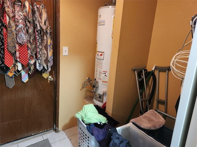 bathroom featuring tile patterned flooring and gas water heater