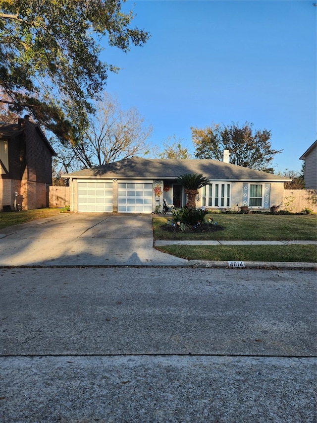 single story home featuring a garage and a front lawn