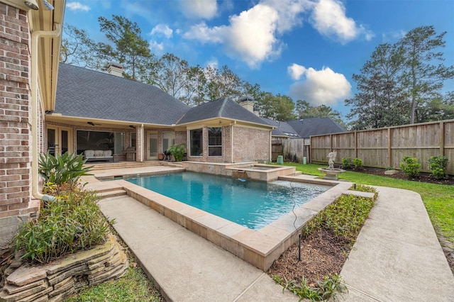 view of swimming pool with a hot tub and a patio area