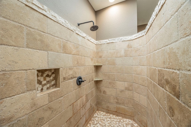 bathroom featuring tiled shower