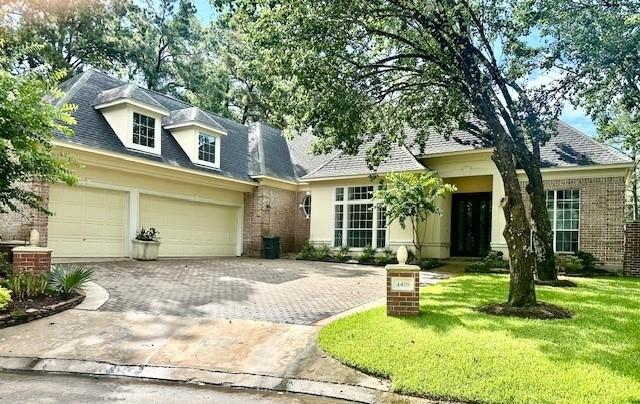 4418 Greens Court Way, Houston, TX 77339 - view of front of property featuring decorative driveway, brick siding, a front lawn, a shingled roof, and a garage