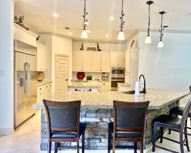 4418 Greens Court Way, Houston, TX 77339 - kitchen with built in appliances, a sink, crown molding, a kitchen bar, and a spacious island