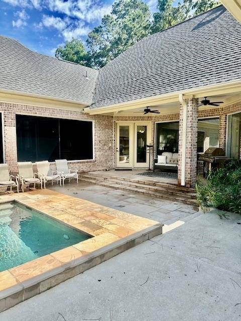 4418 Greens Court Way, Houston, TX 77339 - back of property with brick siding, ceiling fan, roof with shingles, and a patio area