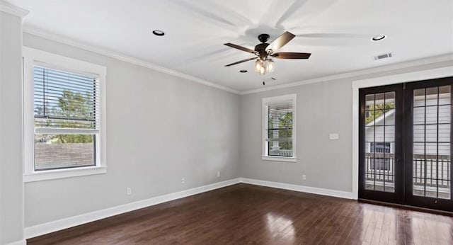 spare room with french doors, dark hardwood / wood-style floors, crown molding, and a healthy amount of sunlight