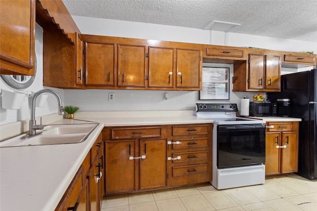 kitchen featuring black appliances, sink, and a textured ceiling