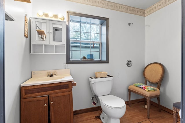 bathroom with hardwood / wood-style floors, vanity, and toilet