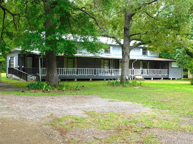 view of front of property with a porch and a front yard