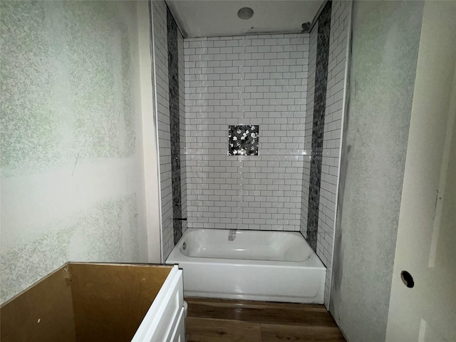 bathroom featuring tiled shower / bath combo and wood-type flooring