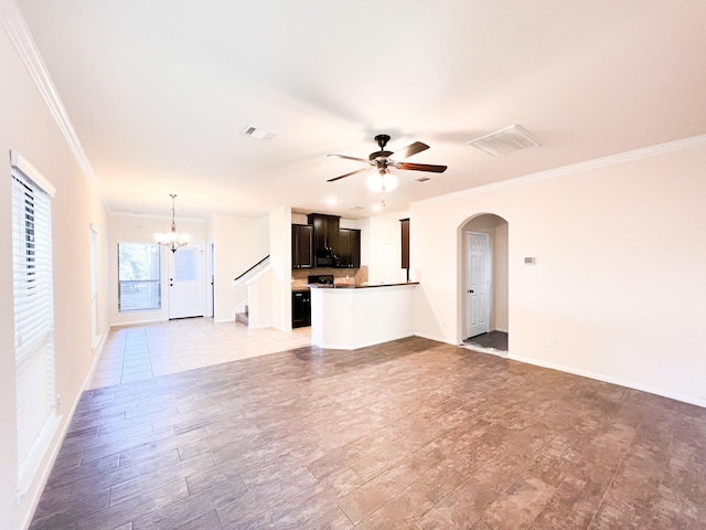 unfurnished living room with crown molding and ceiling fan with notable chandelier