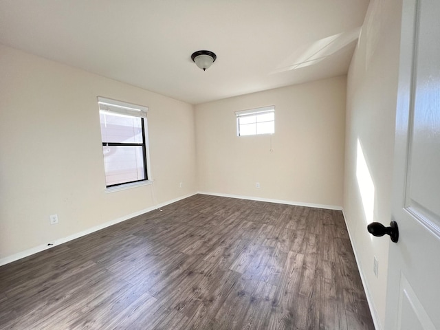 spare room with dark hardwood / wood-style floors