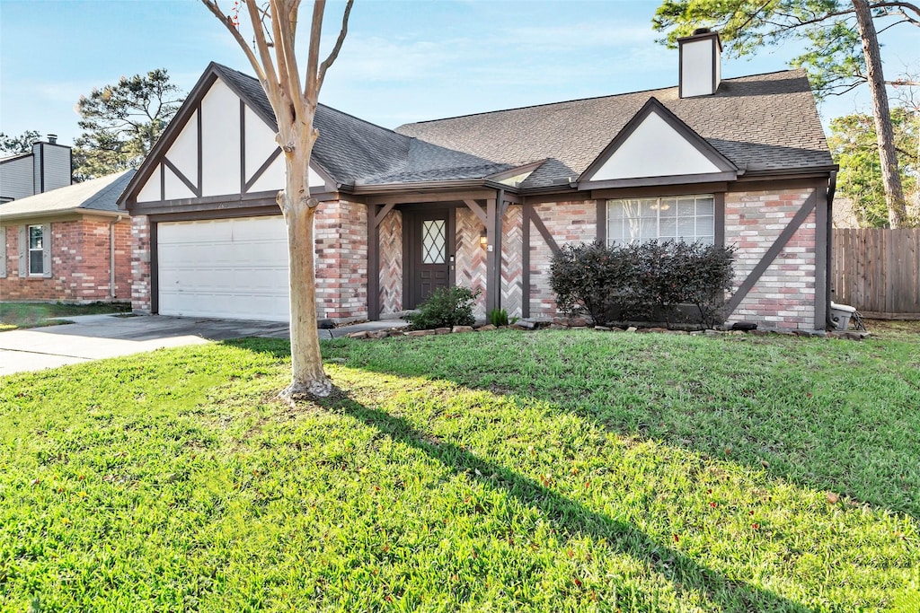 view of front of house featuring a front lawn and a garage