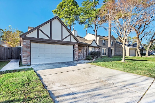 tudor house featuring a front yard and a garage